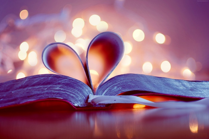 Heart shape from book pages with bokeh lights