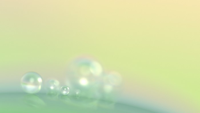 Close-up of iridescent bubbles on a green surface