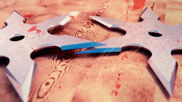 Close up of shurikens with red splatters