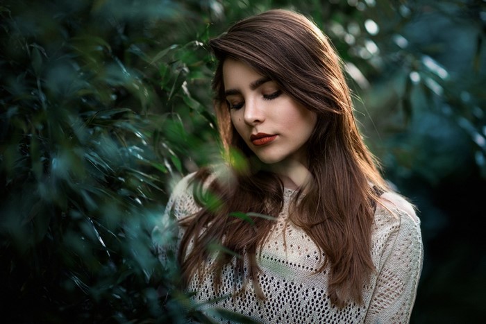 Woman with long brown hair in a forest