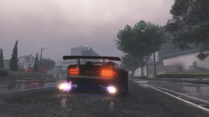 Sports car with flames driving on a wet road
