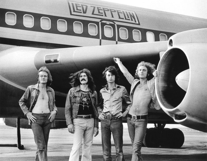 Led Zeppelin band members in front of their airplane