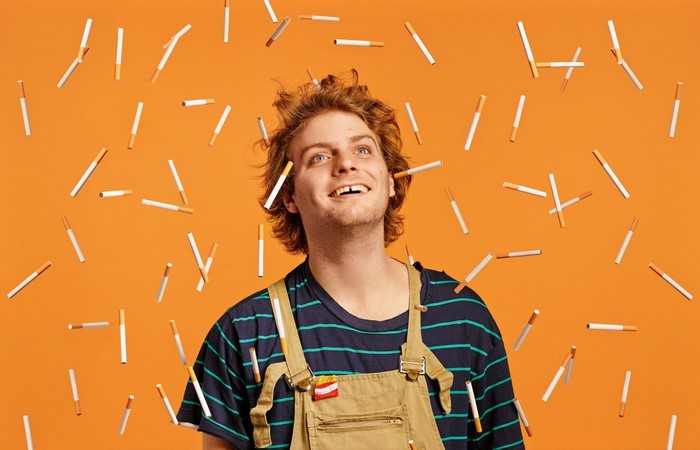 Mac DeMarco surrounded by falling cigarettes