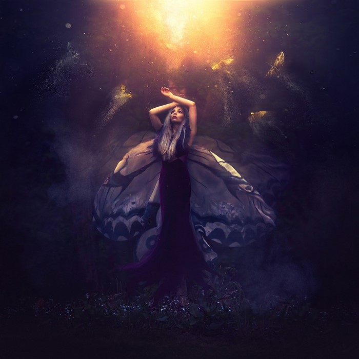 Woman with butterfly wings in dark fantasy setting