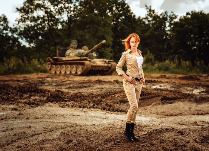Woman in military-style outfit with a tank
