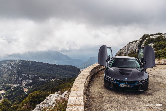 BMW i8 sports car parked on a mountain road
