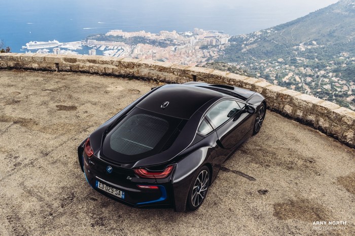 Black BMW i8 parked on a scenic overlook in Monaco