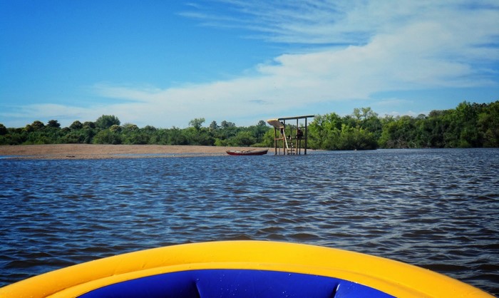 Kayaking on a river with a wooden structure