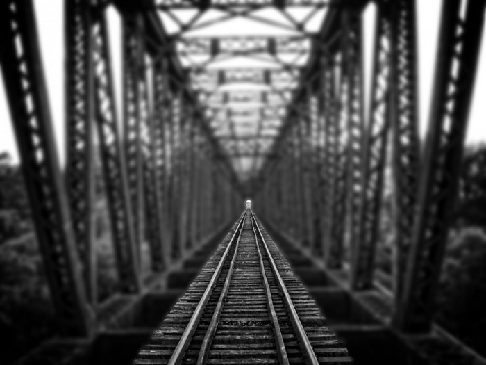 Train tracks on a bridge in monochrome