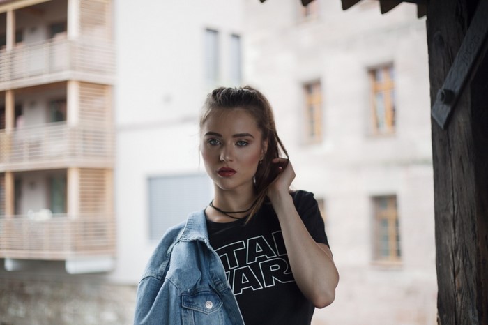Woman wearing Star Wars t-shirt and denim jacket