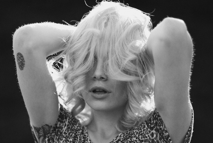 Woman with blonde hair and tattoos