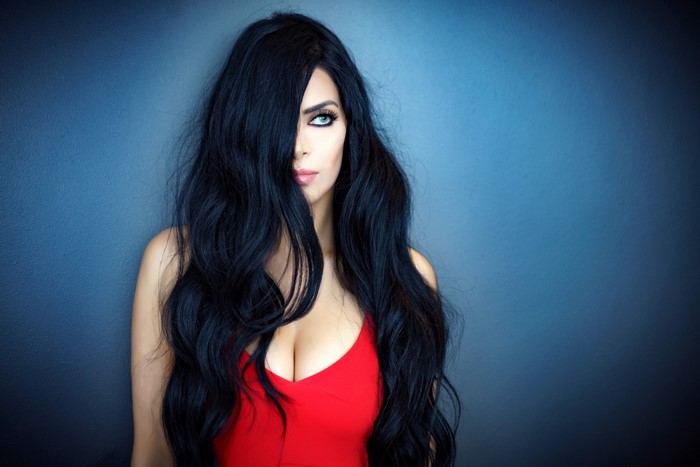 Woman with long black hair in a red top