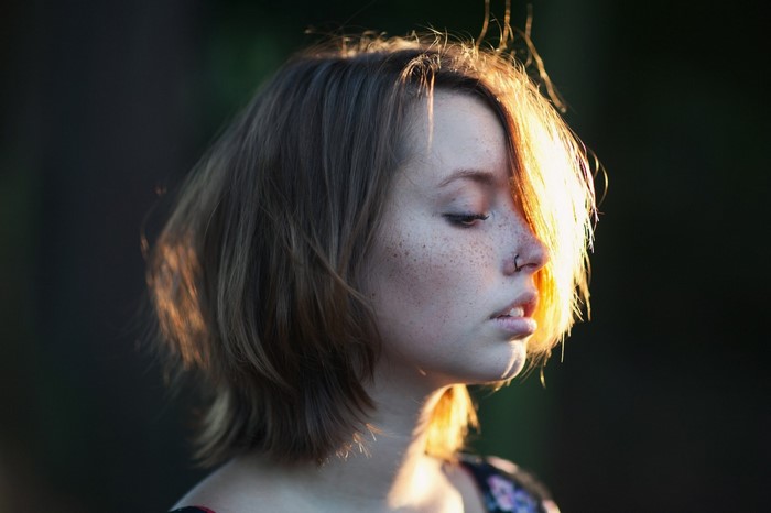 Woman with freckles and nose ring in profile