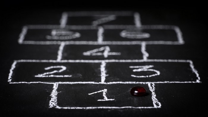 Hopscotch drawn on a blackboard with a marker