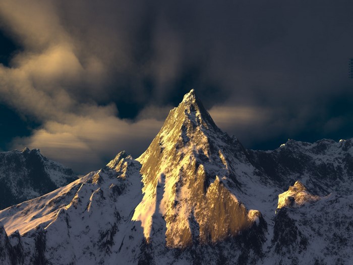 Snow-covered mountain peak illuminated by golden sunlight