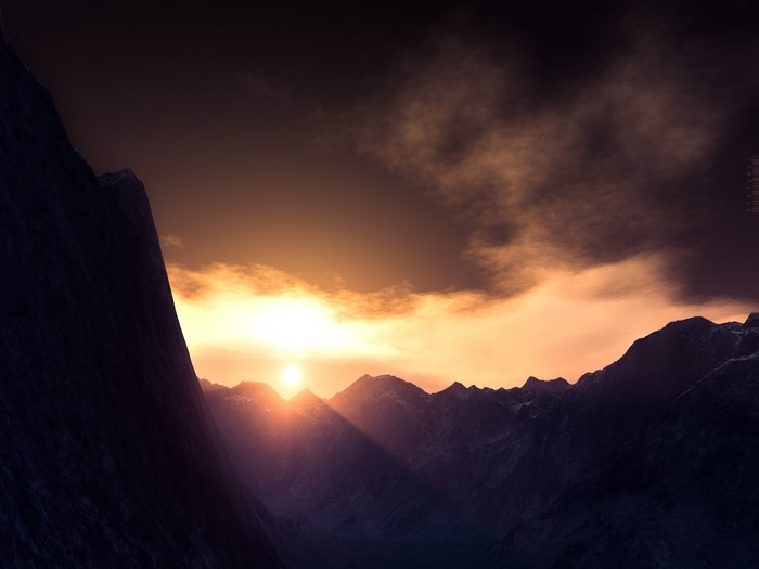 Sunset over a mountain range with dramatic clouds