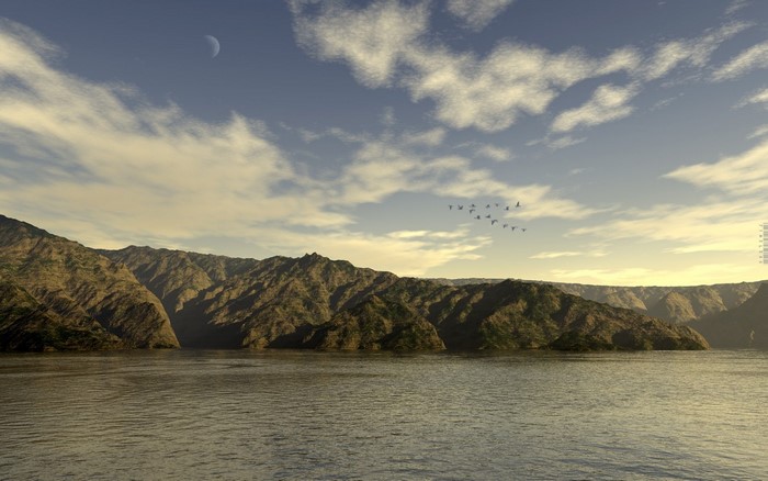 A flock of birds flies over a calm body of water with mountains in the background under a cloudy sky with a crescent moon.