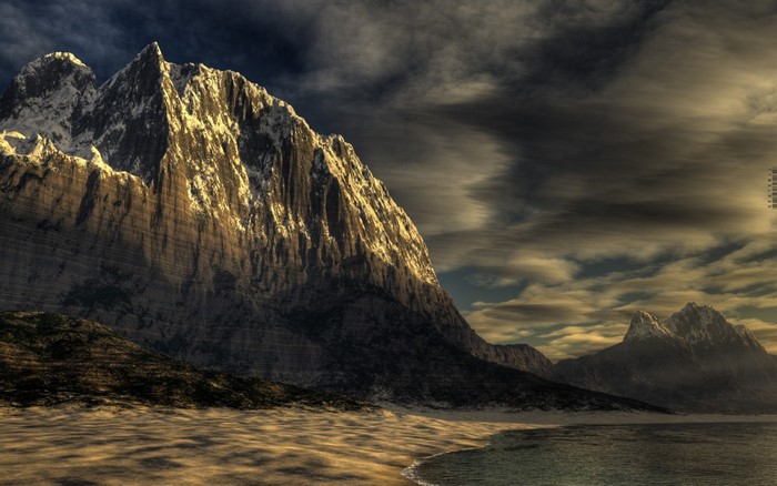 Mountain range with sandy shore and dramatic clouds