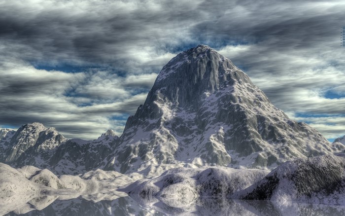 Snowy mountain range under a cloudy sky
