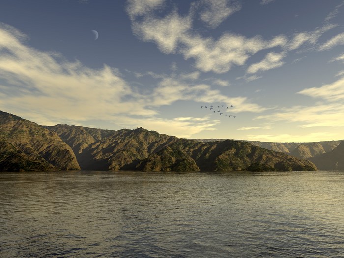Mountainous coast with a body of water and birds flying