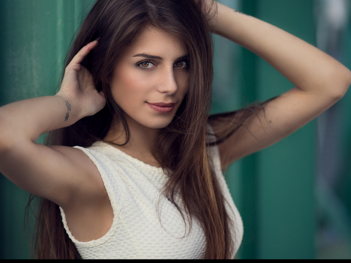 Woman with long brown hair and tattoo