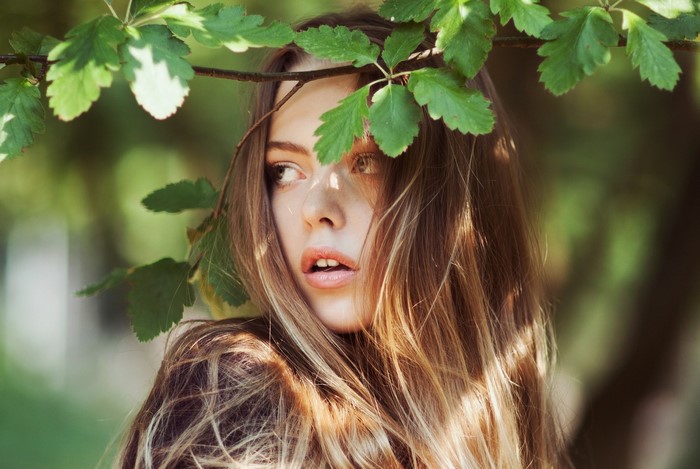 Woman with leaves and sunlight