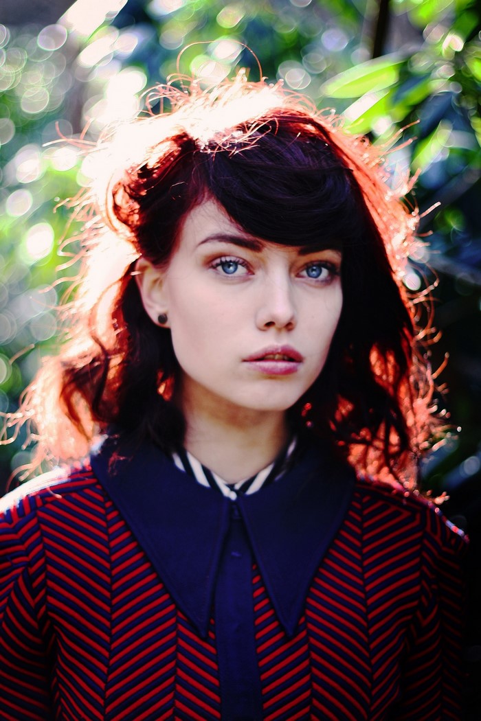 Portrait of a young woman with blue eyes and red hair