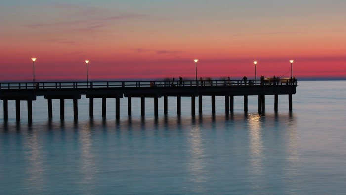 Pier at sunset over the ocean