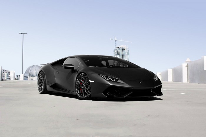 Matte black Lamborghini Huracan on a rooftop parking lot