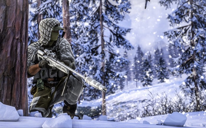 Soldier with sniper rifle in snowy forest