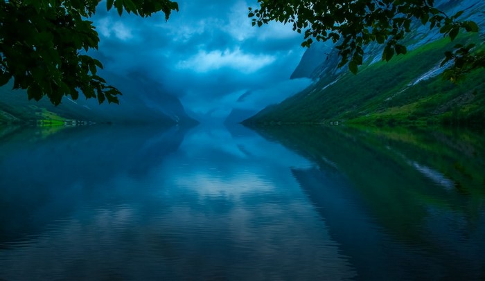 Lake reflection of mountains and clouds in Norway