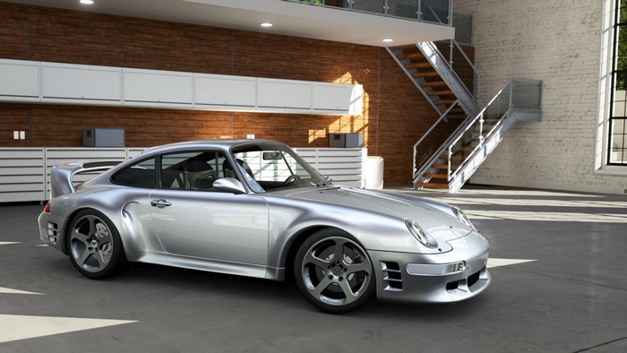 Silver Porsche 911 sports car in a modern garage