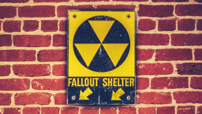 Fallout Shelter sign on brick wall