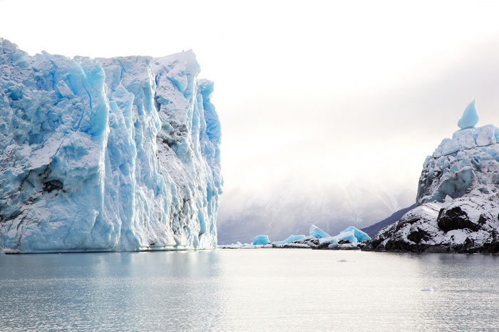 Glacier and icebergs in the ocean