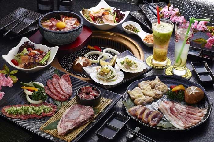 Assortment of Korean BBQ dishes with drinks