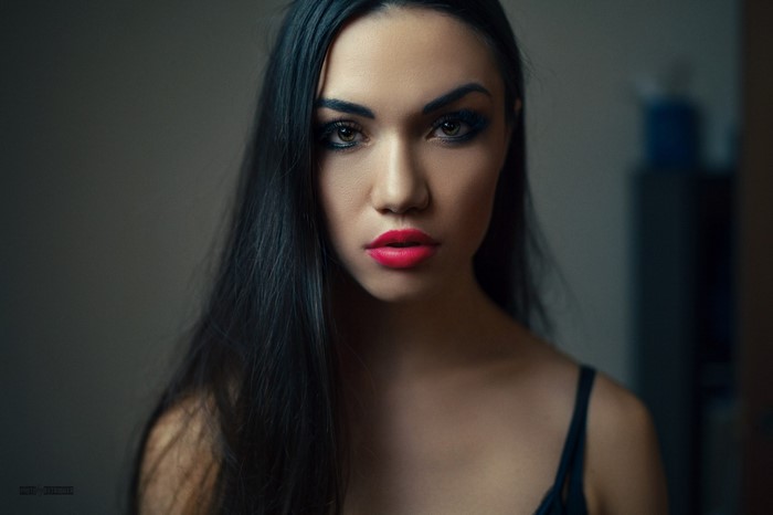 Woman with long black hair and red lipstick
