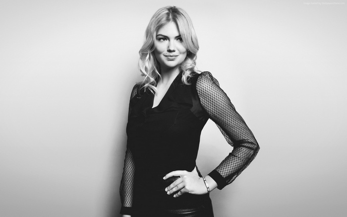 Kate Upton posing in a black top