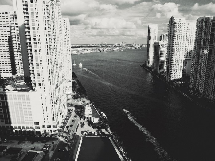Black and white aerial view of Miami cityscape with skyscrapers and river