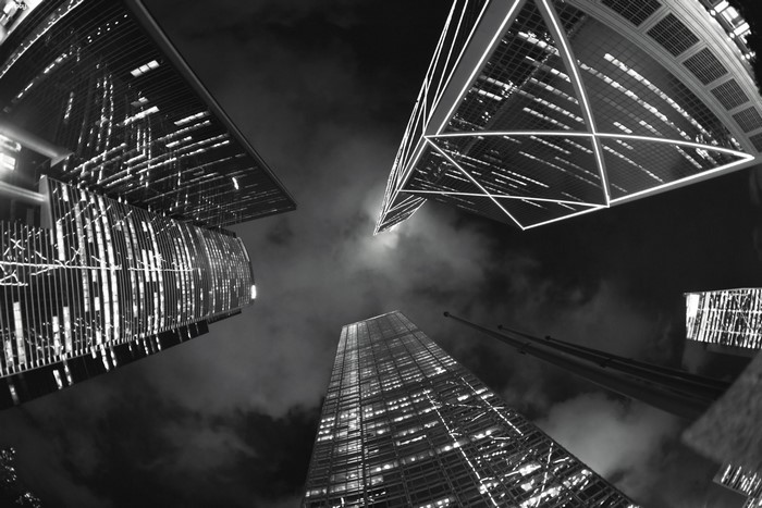 Monochrome night cityscape with skyscrapers looking up