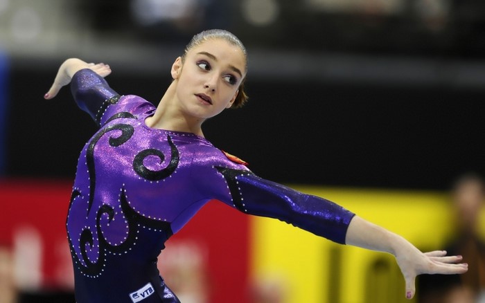 Aliya Mustafina performing artistic gymnastics