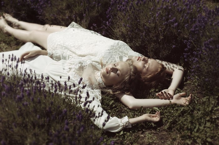 Two women lying in a lavender field