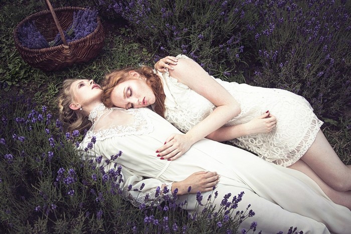 Two women lying in a lavender field