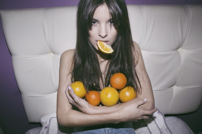Woman with oranges and orange slice