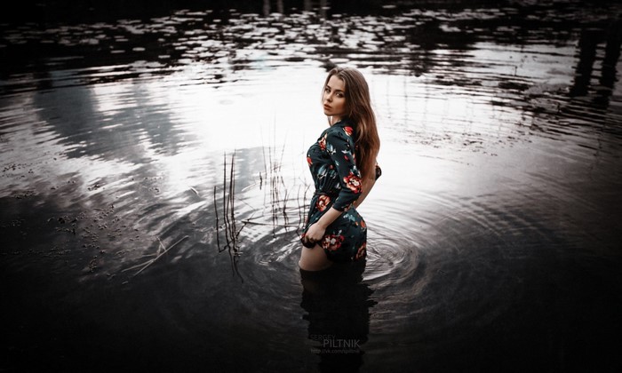 Woman in floral dress standing in water