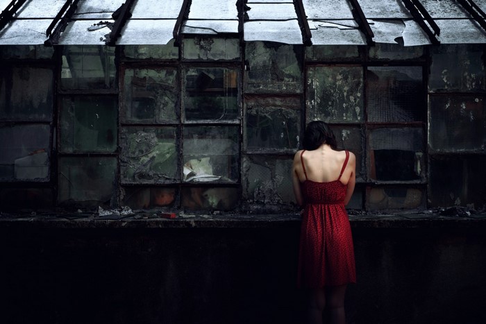 Woman in red dress in abandoned building