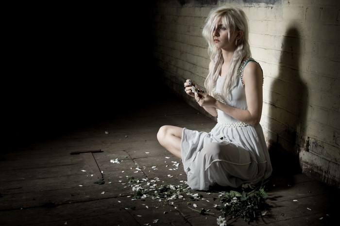Woman sitting on floor with white flowers