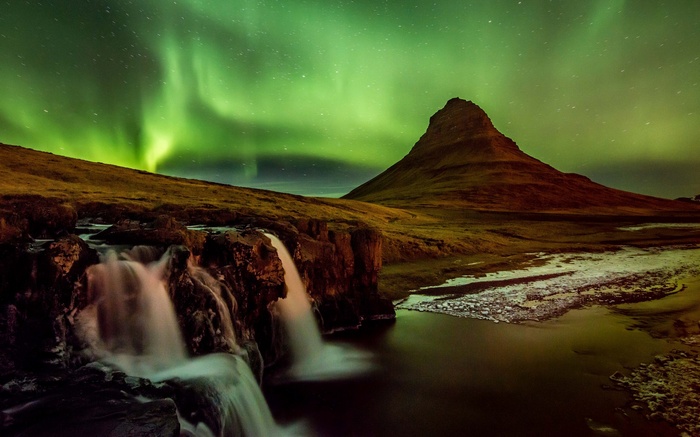 Kirkjufell mountain and waterfall under aurora borealis