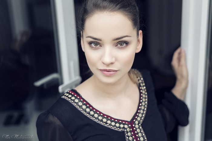Woman with yellow eyes in black dress