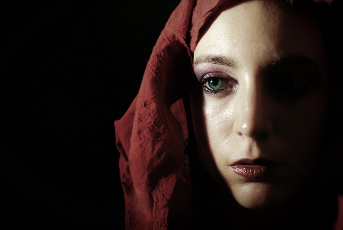 Woman with red headscarf and blue eye