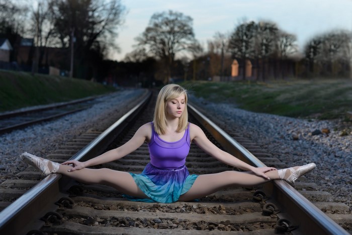 Ballerina Stretching on Railway Tracks